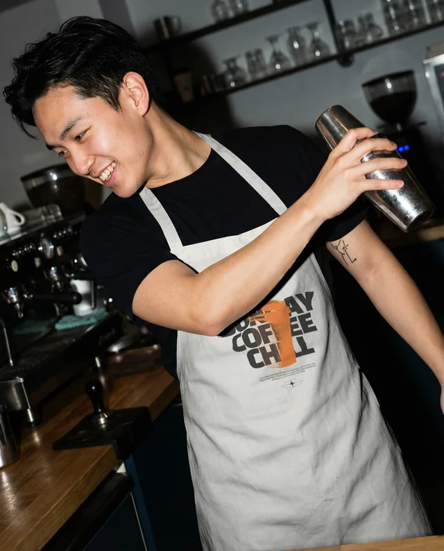 Modern Bartender Mockup with White Apron in Café Setting