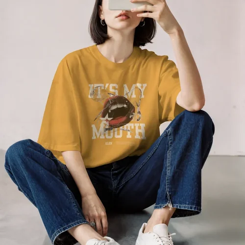 Stylish T-Shirt Mockup of a Young Woman Relaxing